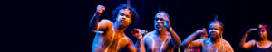 A group of indigenous performers on stage performing.