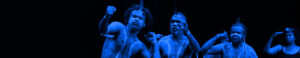 A group of indigenous performers on stage performing.